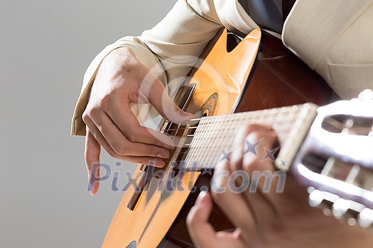 Close up of male hands playing acoustic guitar Close up of male hands playing acoustic guitar