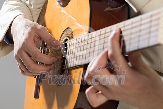 Close up of male hands playing acoustic guitar Close up of male hands playing acoustic guitar