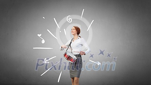 Young businesswoman on color background playing drums