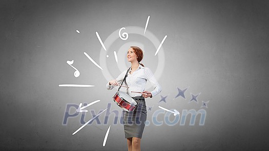 Young businesswoman on color background playing drums Young businesswoman on color background playing drums