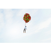 Young successful businessman flies on bunch of colorful balloons
