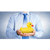 Businessman holding in hands yellow toy rubber or plastic duck