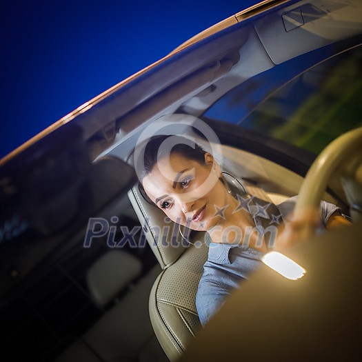Pretty, young woman  driving a car -Invitation to travel. Car rental,  car ownership or vacation