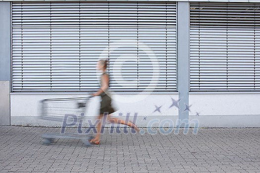 Pretty, young woman going grocery shopping with a trolley Pretty, young woman going grocery shopping with a trolley