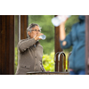 Handsome senior man drinking mineral water in a spa/health resort, enjoying its health benefits
