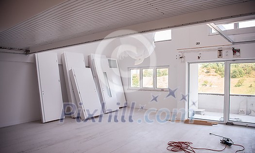 Interior doors stacked in a new apartment waiting for installation