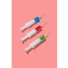 Three sterile disposable syringes 20 ml with red, green and blue serum or drugs for an intravenous injection and vaccinaction on a living coral background with hard shadow, copy space.