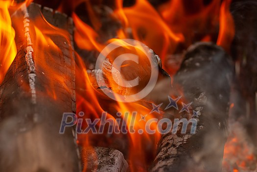 Open fire burning wood background with copy space. Macro view. Can be used for your creativity. Open fire burning wood background with copy space. Macro view. Can be used for your creativity.