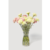 Big bouquet of freshly picked beautiful carnation flowers white and pink in a glass vase on a light grey background with soft shadows, copy space. Congratulation card.
