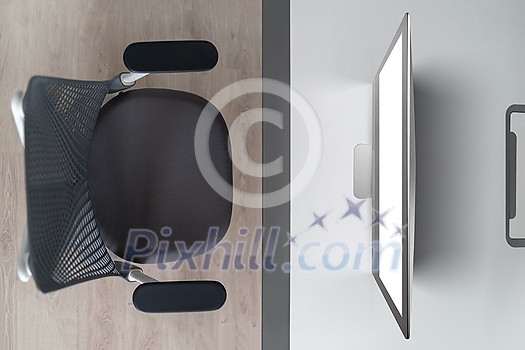 Modern comfortable workspace - computer desk with mockup white computer monitor and orthopaedic chair. Top view. Home working outside office concept. Modern comfortable workspace - computer desk with mockup white computer monitor and orthopaedic chair. Top view. Home working outside office concept.