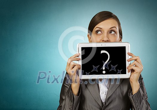 Beautiful young woman holding tablet with question against her mouth