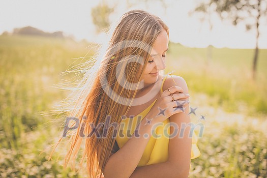 Portrait of young, pretty  woman outdoor on a summer sunny day
