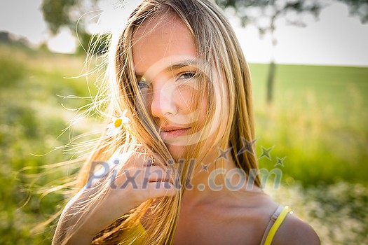 Portrait of young, pretty  woman outdoor on a summer sunny day