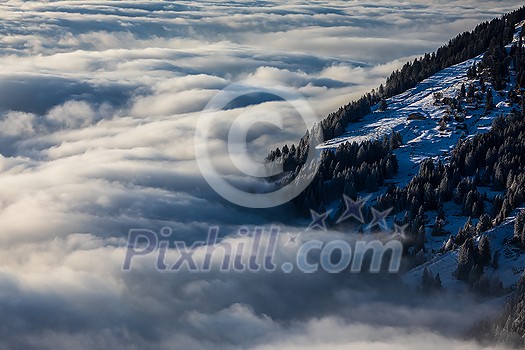 Splendid apline scenery. High mountains with fog and lovely evening light.