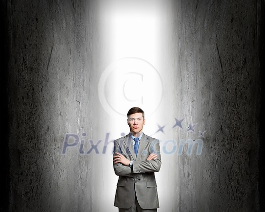 Young confident businessman with hands crossed on chest between two walls Young confident businessman with hands crossed on chest between two walls