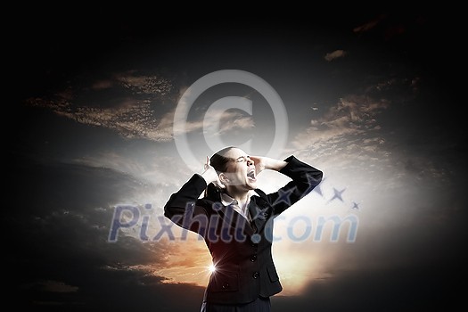 Young frustrated businesswoman covering ears with hands and screaming loud Young frustrated businesswoman covering ears with hands and screaming loud