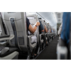 Interior of commercial airplane with passengers in their seats during flight.