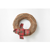 Decorative handmade festive wreath from twigs with textile bow ribbon against white background, copy space. Greeting card.