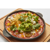 Homemade fresh traditional dish Shakshuka from fried eggs, tomatoes, pepper, vegetables and herbs in a pan on a wooden board on a light grey background, copy space. Middle eastern traditional dish.