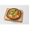 Homemade shakshouka dish cooked from fresh fried eggs with tomatoes, pepper, vegetables and herbs in a pan on a wooden board on a light grey background, copy space. Middle eastern traditional dish.