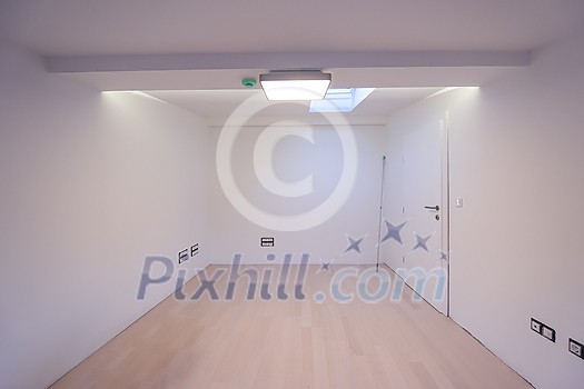 interior of empty room with hardwood floor,roof window and air conditioner on white wall ready for moving at new luxury apartment