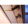 close up of door handle in room interior with Key in the lock
