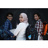 Arabic teenagers, students group  portrait against black chalkboard wearing backpack and books in school