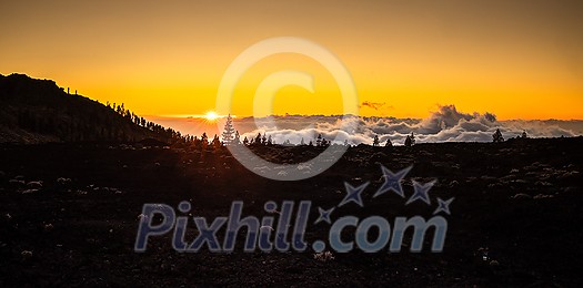 Colorful scenic landscape of moon rise in Tenerife national park of Teide. El Teide with moon rising by its side.