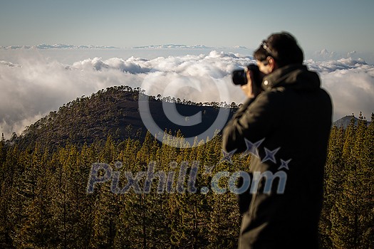 Photographer taking photos of a lovely landscape Photographer taking photos of a lovely landscape