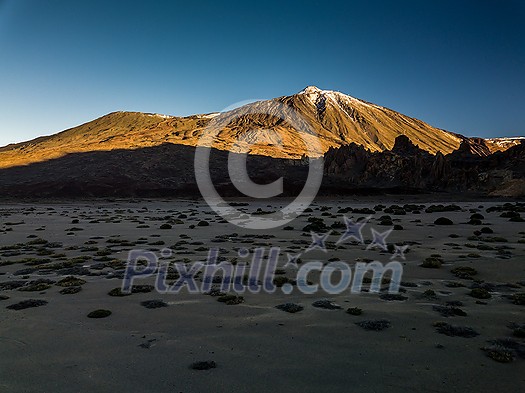 Peaks of Teide and Pico Viejo volcanoes at sunset seen from the Samara crater. Teide National Park, Tenerife, Canary Islands, Spain