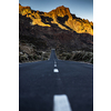 Long road in a mountain valley with a car on it - Teide National Park, Tenerife, Canary islands