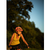 Pretty, young woman biking on a mountain bike enjoying healthy active lifestyle outdoors in summer (shallow DOF)