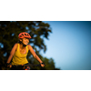 Pretty, young woman biking on a mountain bike enjoying healthy active lifestyle outdoors in summer (shallow DOF)