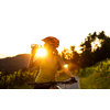 Pretty, young woman biking on a mountain bike enjoying healthy active lifestyle outdoors in summer (shallow DOF)
