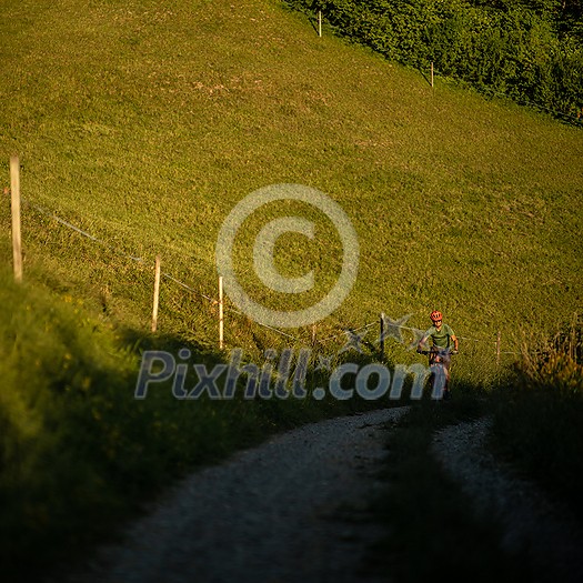 Handsome young man biking on a mountain bike enjoying healthy active lifestyle outdoors in summer (shallow DOF) Handsome young man biking on a mountain bike enjoying healthy active lifestyle outdoors in summer (shallow DOF)