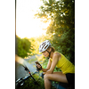 Pretty, young woman biking on a mountain bike enjoying healthy active lifestyle outdoors in summer (shallow DOF)