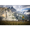 Pretty, female climber on a via ferrata - climbing on a rock in Swiss Alps