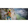 Young, male climber on a via ferrata route - climbing on a rock in Swiss Alps