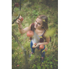 Cute girl picking apples in an orchard having fun harvesting the ripe fruits of her family's labour (color toned image)