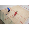 Squash players in action on a squash court (motion blurred image; color toned image)