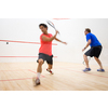 Squash players in action on a squash court (motion blurred image; color toned image)