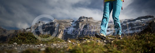 Pretty, young female hiker walking in high mountains (shallow DOF) Pretty, young female hiker walking in high mountains (shallow DOF)