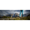 Pretty, young female hiker walking in high mountains (shallow DOF)