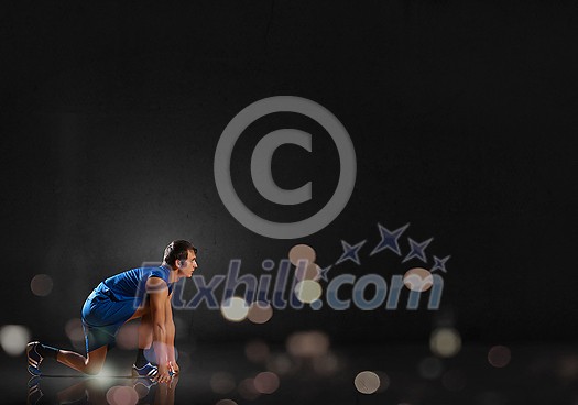 Young man athlete standing in start pose Young man athlete standing in start pose