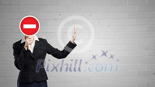 Businesswoman hiding her face behind mask and showing stop gesture Businesswoman hiding her face behind mask and showing stop gesture
