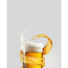 A glass of cold fresh beer with thick white foam and splash around it on a gray background, copy space. Alcohol drinks concept.
