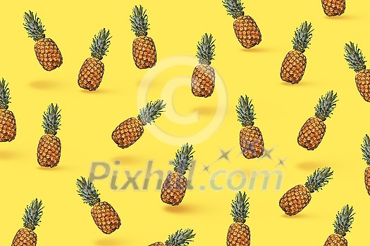 Pattern of slices and whole tropical pineapple fruit on a blue background with space for text. Flat lay