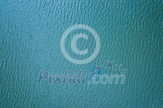 Beautiful seascape aerial view from drone above turquoise color water of sea or ocean surface with boat or ship, copy space. Top view.