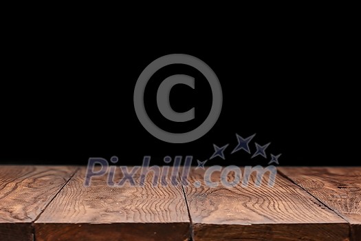 Blank wooden deck table against black wallpaper background for present product and other things. Can be used for your creativity. Blank wooden deck table against black wallpaper background for present product and other things. Can be used for your creativity.