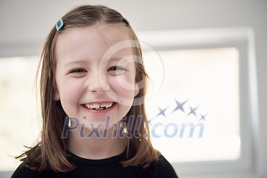 Funny little girl without tooth smiles showing gap close up Funny little girl without tooth smiles showing gap close up